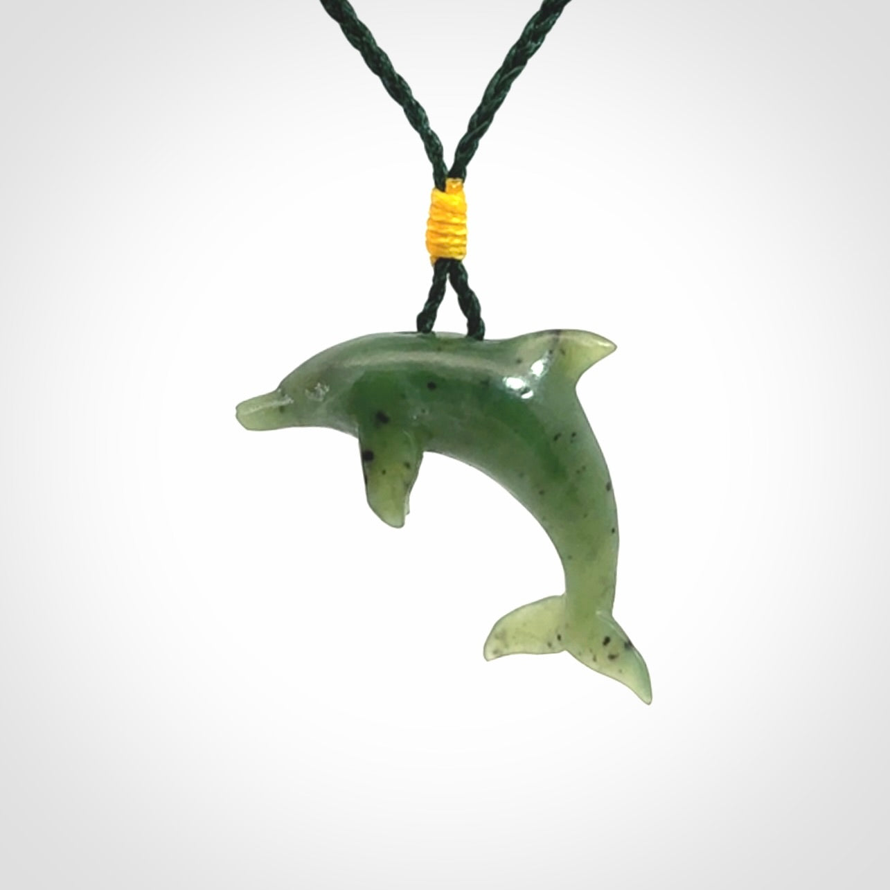 This is a gorgeous little dolphin pendant carved in green nephrite jade. The cord is fine and length adjustable so you can position the little jade dolphin where it suits you best. Shipping is free worldwide.