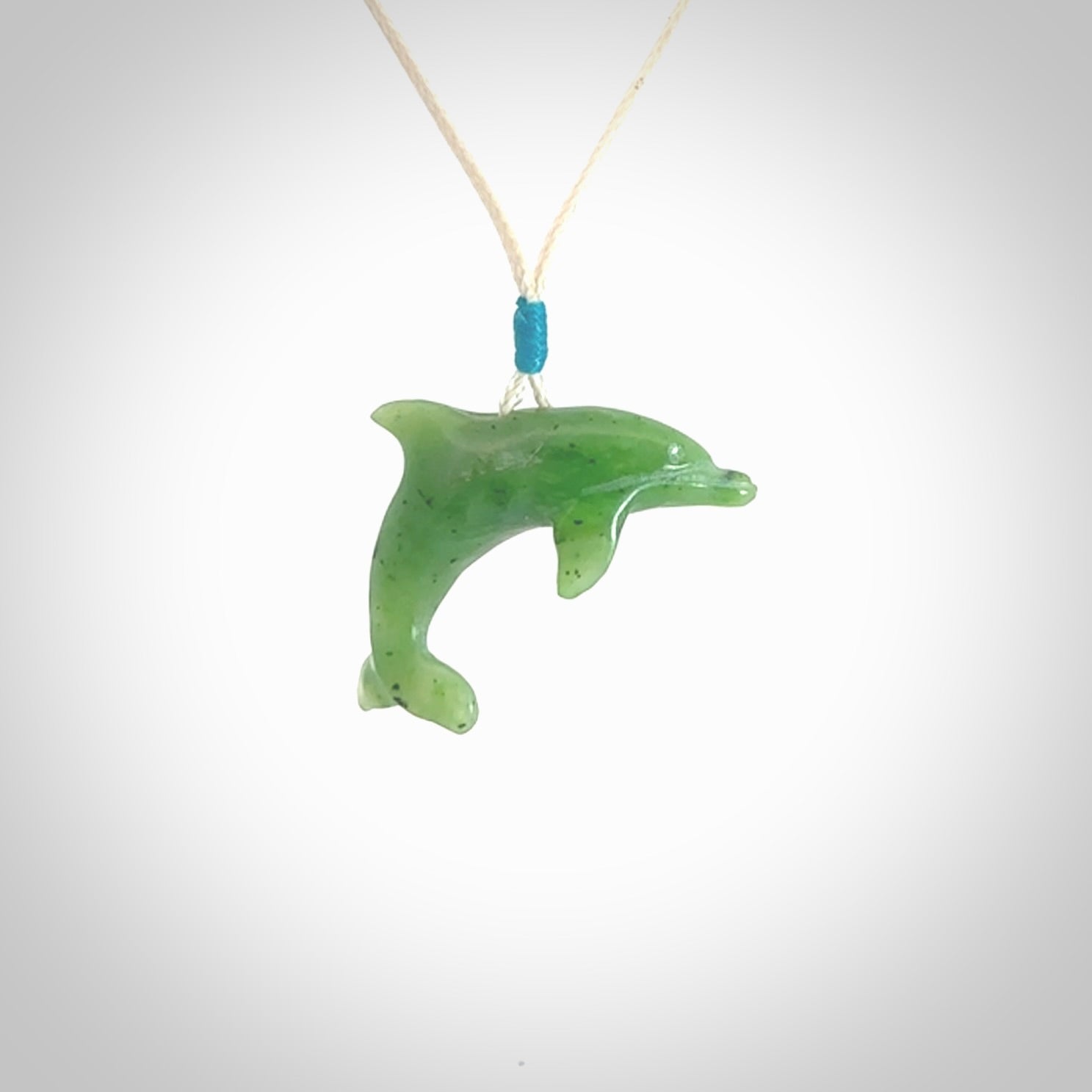This is a gorgeous little dolphin pendant carved in green nephrite jade. The cord is fine and length adjustable so you can position the little jade dolphin where it suits you best. Shipping is free worldwide.