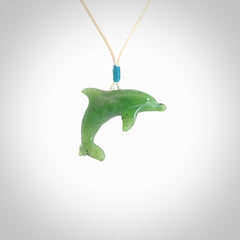 This is a gorgeous little dolphin pendant carved in green nephrite jade. The cord is fine and length adjustable so you can position the little jade dolphin where it suits you best. Shipping is free worldwide.
