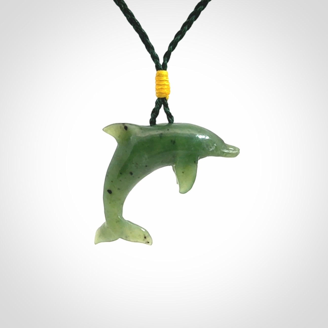 This is a gorgeous little dolphin pendant carved in green nephrite jade. The cord is fine and length adjustable so you can position the little jade dolphin where it suits you best. Shipping is free worldwide.