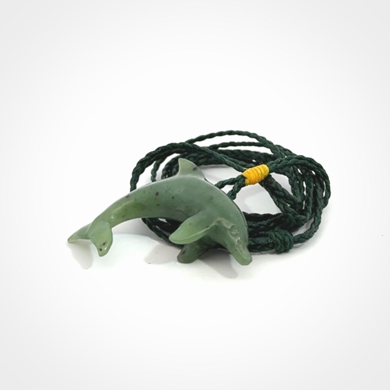 This is a gorgeous little dolphin pendant carved in green nephrite jade. The cord is fine and length adjustable so you can position the little jade dolphin where it suits you best. Shipping is free worldwide.