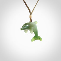 This is a gorgeous little dolphin pendant carved in green nephrite jade. The cord is fine and length adjustable so you can position the little jade dolphin where it suits you best. Shipping is free worldwide.