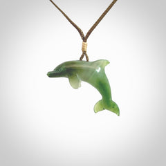 This is a gorgeous little dolphin pendant carved in green nephrite jade. The cord is fine and length adjustable so you can position the little jade dolphin where it suits you best. Shipping is free worldwide.