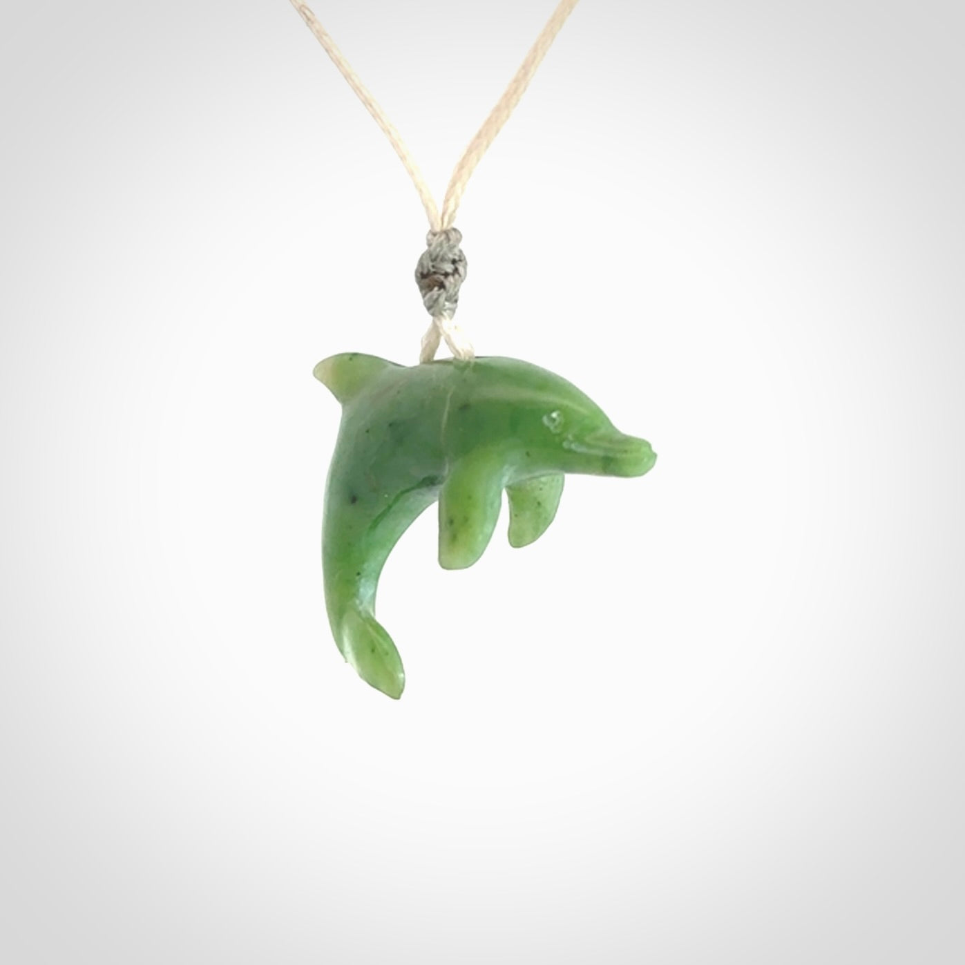 This is a gorgeous little dolphin pendant carved in green nephrite jade. The cord is fine and length adjustable so you can position the little jade dolphin where it suits you best. Shipping is free worldwide.