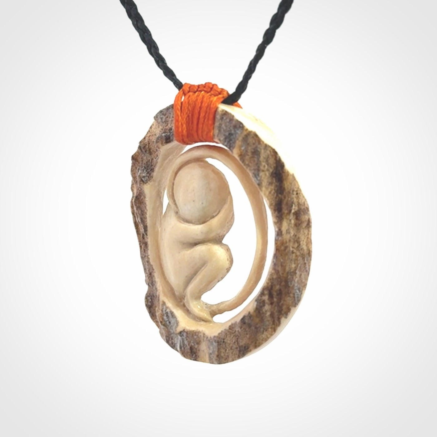 Hand carved deer antler fetus pendant. Hand carved by NZ Pacific. Free postage worldwide. Hand made fetus necklace from deer antler. Fetus necklace for men and women. Delivered with adjustable and packaged in a woven kete pouch.