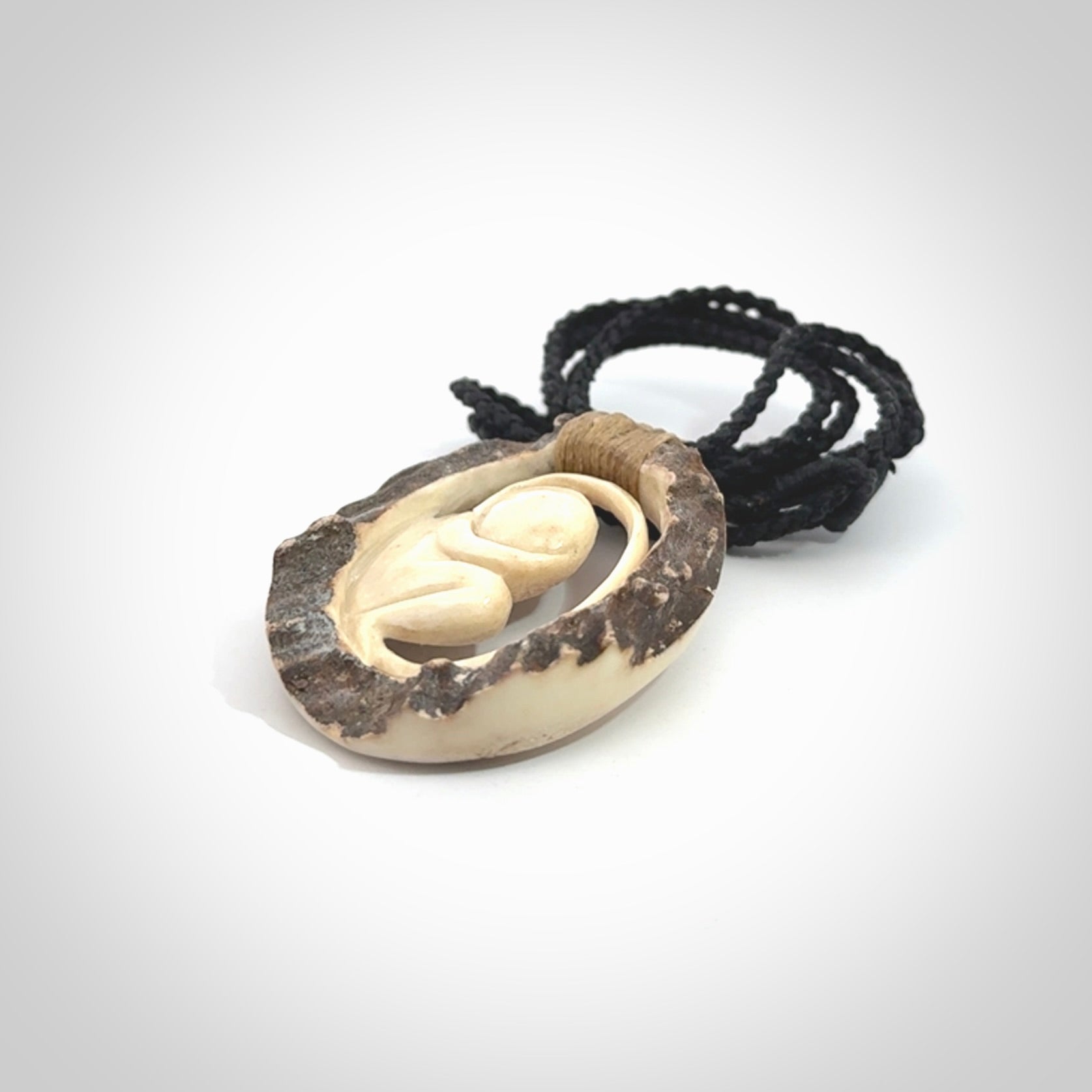 Hand carved deer antler fetus pendant. Hand carved by NZ Pacific. Free postage worldwide. Hand made fetus necklace from deer antler. Fetus necklace for men and women. Delivered with adjustable and packaged in a woven kete pouch.