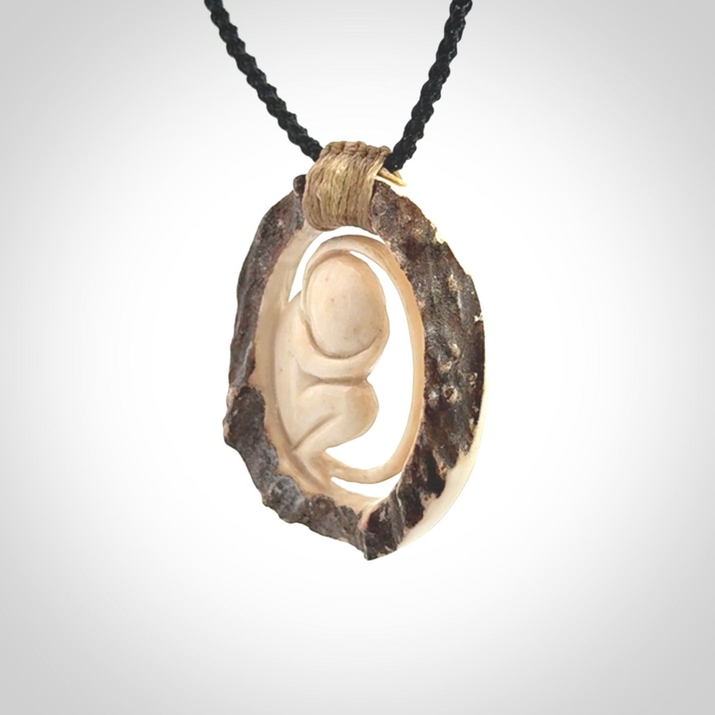 Hand carved deer antler fetus pendant. Hand carved by NZ Pacific. Free postage worldwide. Hand made fetus necklace from deer antler. Fetus necklace for men and women. Delivered with adjustable and packaged in a woven kete pouch.