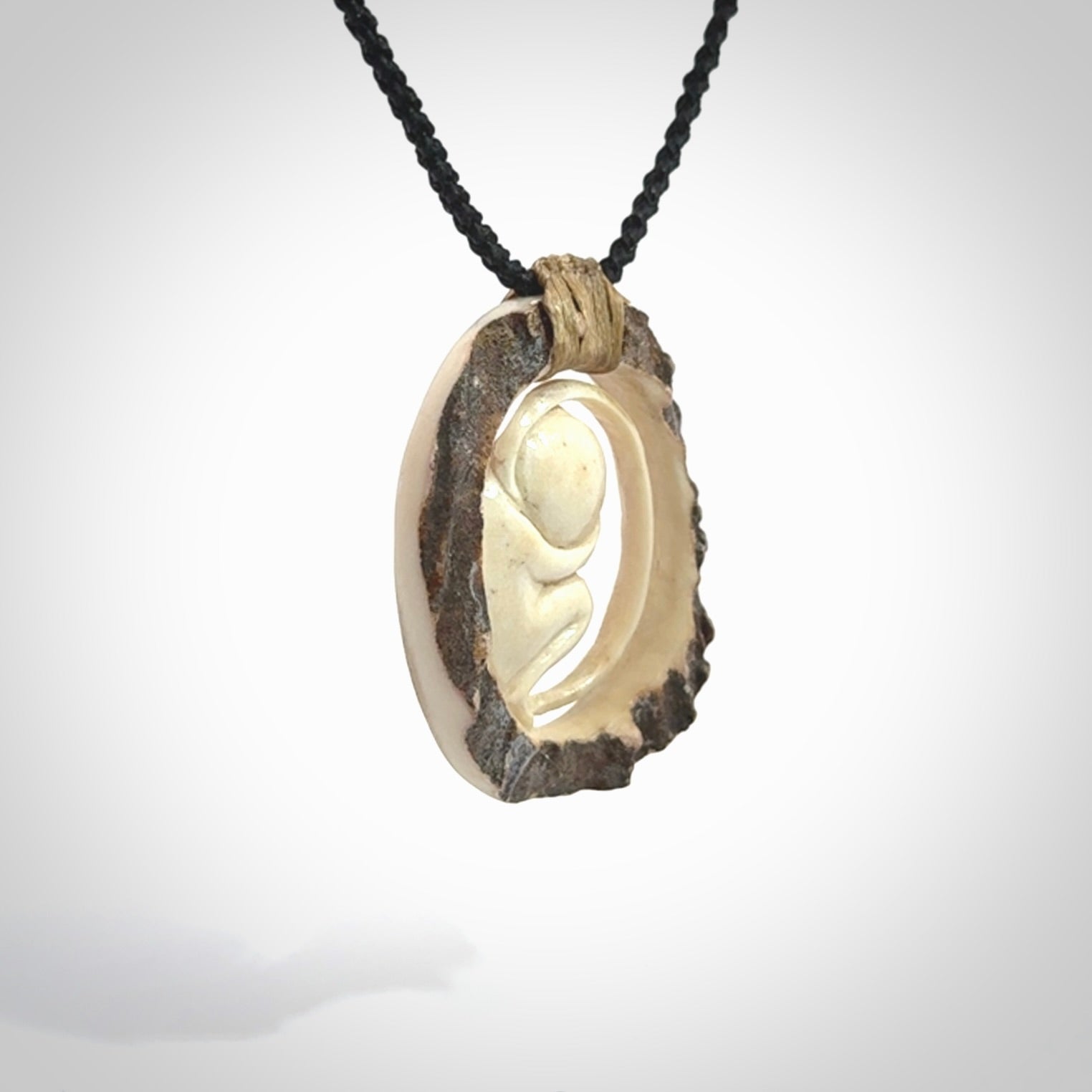 Hand carved deer antler fetus pendant. Hand carved by NZ Pacific. Free postage worldwide. Hand made fetus necklace from deer antler. Fetus necklace for men and women. Delivered with adjustable and packaged in a woven kete pouch.