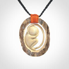 Hand carved deer antler fetus pendant. Hand carved by NZ Pacific. Free postage worldwide. Hand made fetus necklace from deer antler. Fetus necklace for men and women. Delivered with adjustable and packaged in a woven kete pouch.
