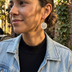 Woman wearing bone earrings