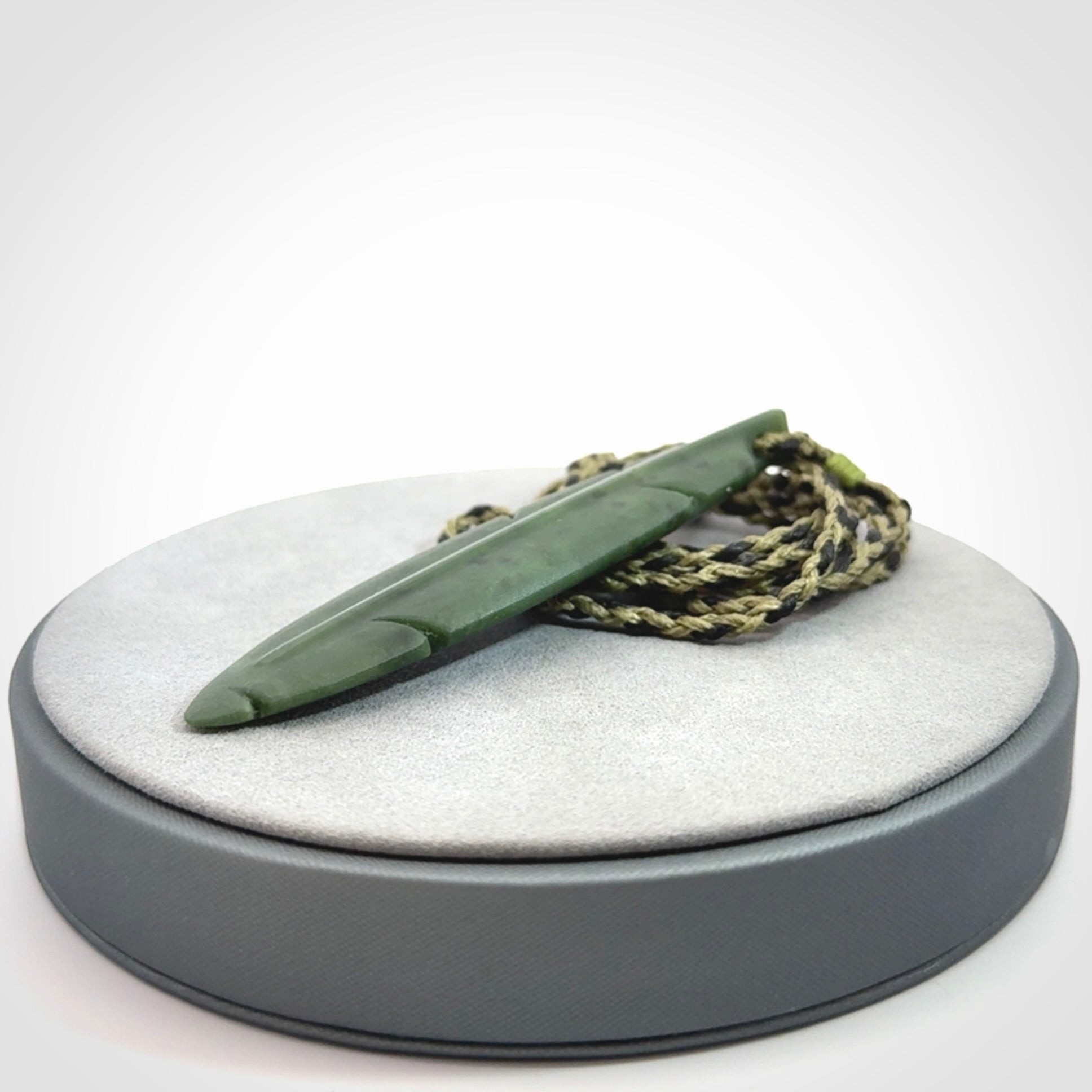 A hand carved large New Zealand Jade feather necklace. The cord is a black/khaki colour and is adjustable. A large sized hand made Jade feather necklace by New Zealand artist Kerry Thompson. One off work of art to wear.