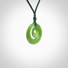 Hand carved New Zealand Kawakawa jade koru pendant. Carved for NZ Pacific by Ross Crump. Jade jewelry for sale online exclusively with NZ Pacific.