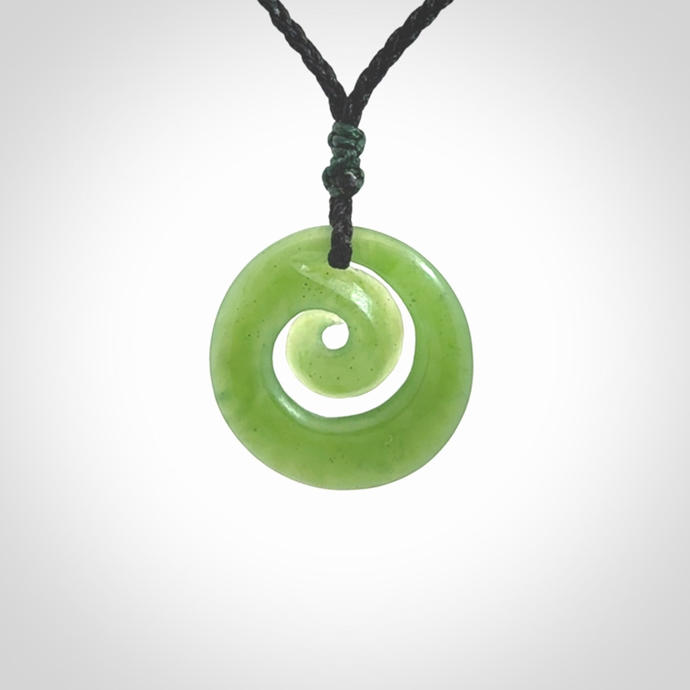 Hand carved New Zealand Kawakawa jade koru pendant. Carved for NZ Pacific by Ross Crump. Jade jewelry for sale online exclusively with NZ Pacific.