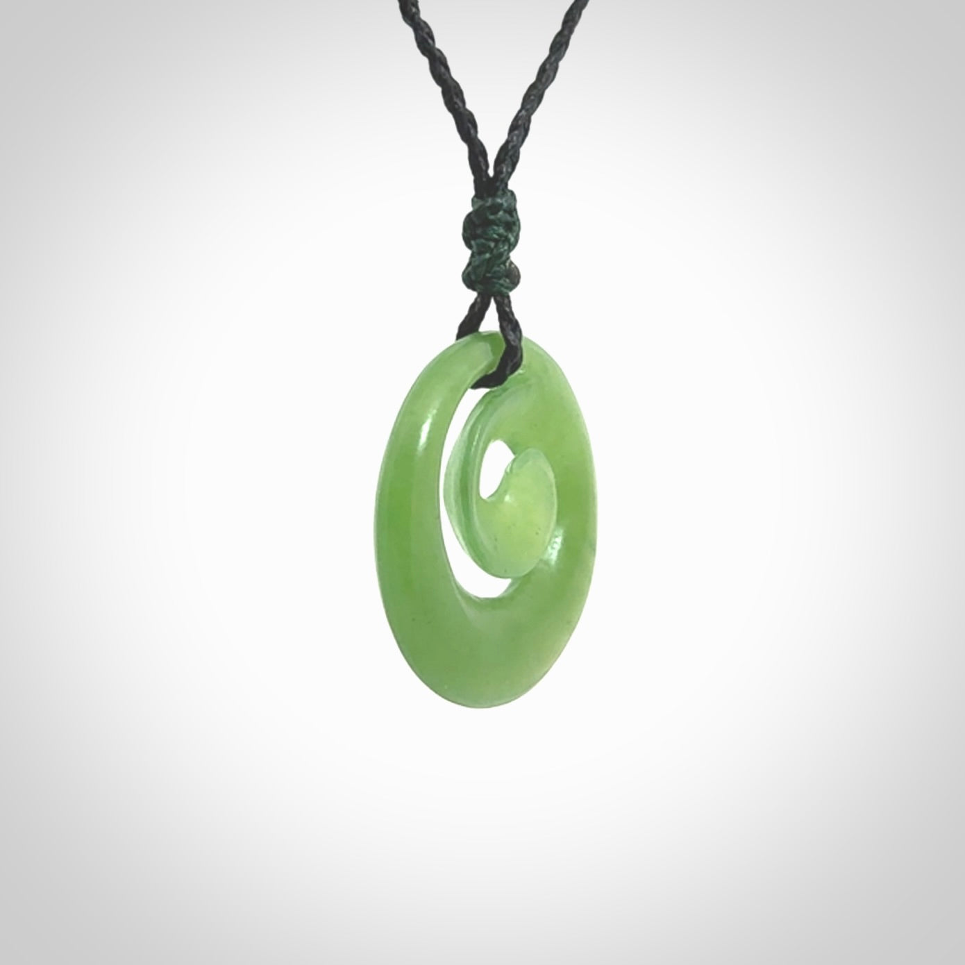 Hand carved New Zealand Kawakawa jade koru pendant. Carved for NZ Pacific by Ross Crump. Jade jewelry for sale online exclusively with NZ Pacific.