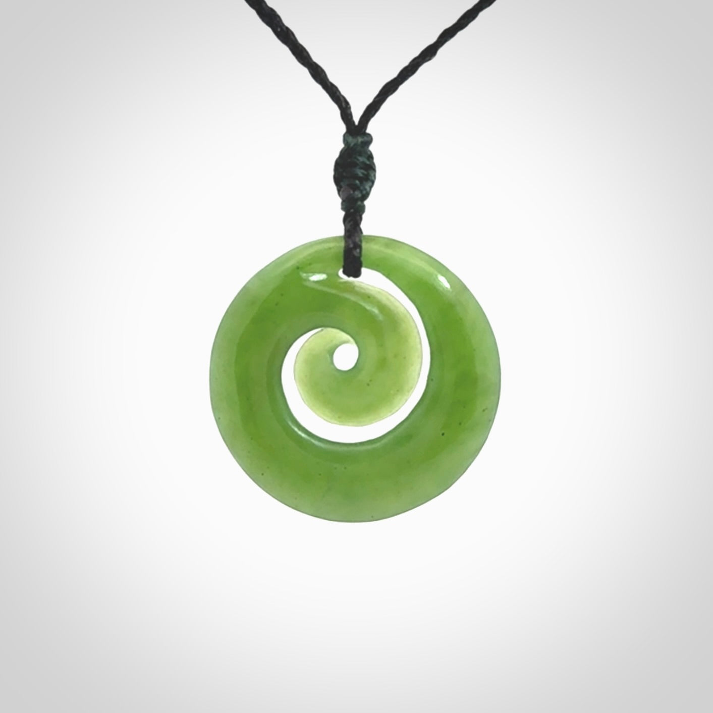 Hand carved New Zealand Kawakawa jade koru pendant. Carved for NZ Pacific by Ross Crump. Jade jewelry for sale online exclusively with NZ Pacific.