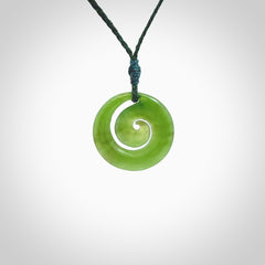 Hand carved New Zealand Kawakawa jade koru pendant. Carved for NZ Pacific by Ross Crump. Jade jewelry for sale online exclusively with NZ Pacific.