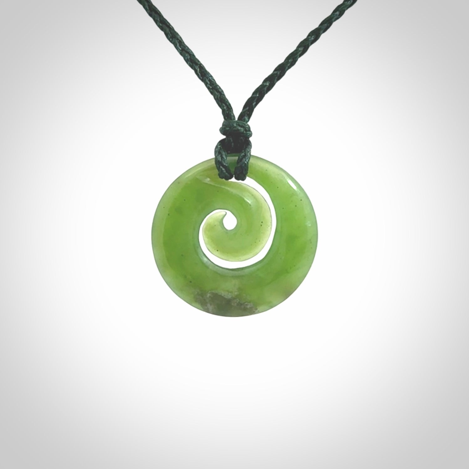 Hand carved New Zealand Kawakawa jade koru pendant. Carved for NZ Pacific by Ross Crump. Jade jewelry for sale online exclusively with NZ Pacific.