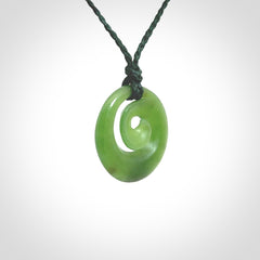 Hand carved New Zealand Kawakawa jade koru pendant. Carved for NZ Pacific by Ross Crump. Jade jewelry for sale online exclusively with NZ Pacific.
