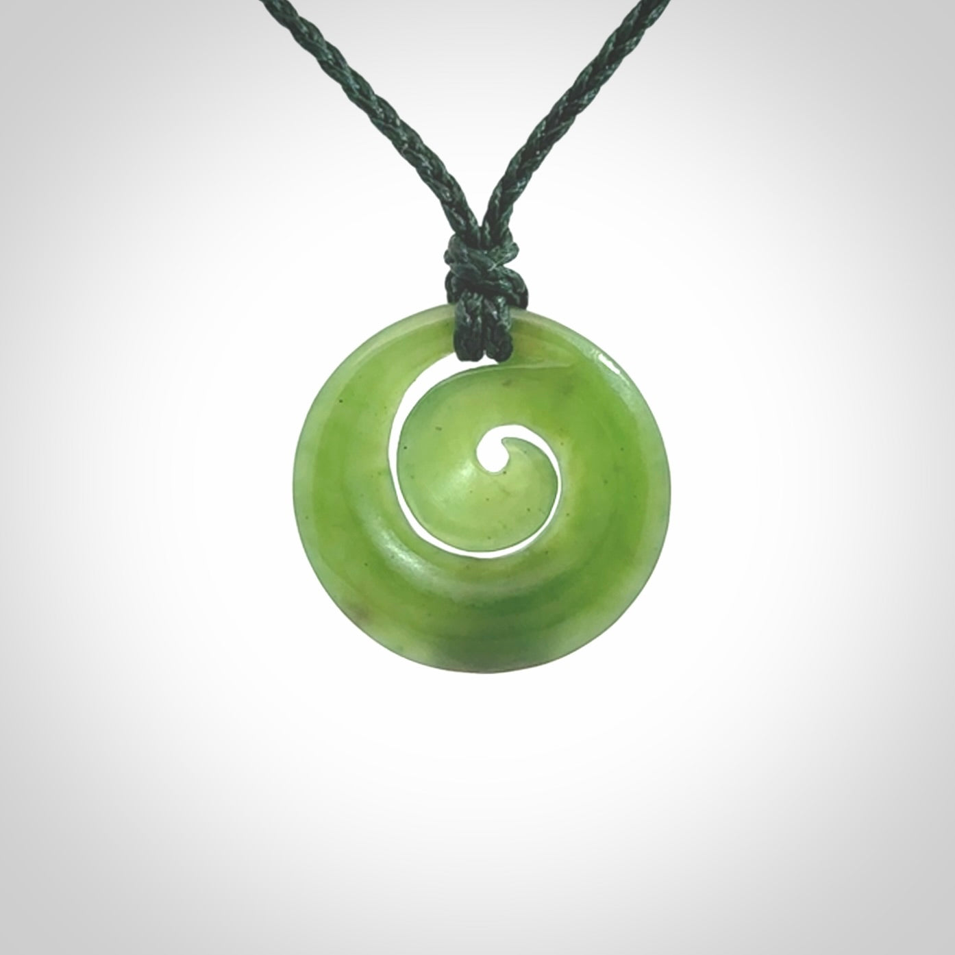 Hand carved New Zealand Kawakawa jade koru pendant. Carved for NZ Pacific by Ross Crump. Jade jewelry for sale online exclusively with NZ Pacific.