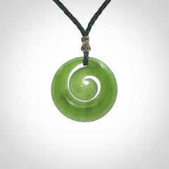 Hand carved New Zealand Kawakawa jade koru pendant. Carved for NZ Pacific by Ross Crump. Jade jewelry for sale online exclusively with NZ Pacific.