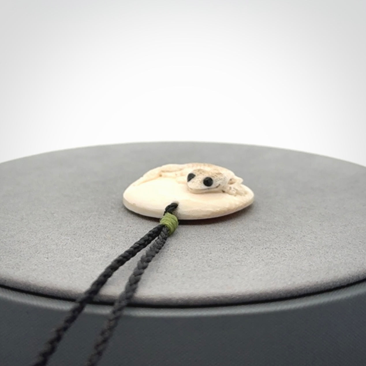 A smiling little lizard pendant