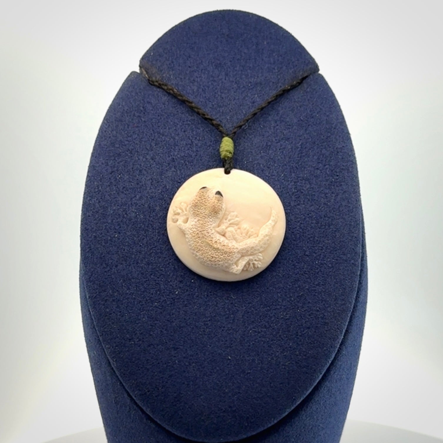 A smiling little lizard pendant