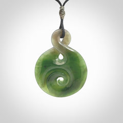 Hand carved New Zealand Jade Twist with Koru heart pendant. Unique Jade jewellery online for sale. Hand made Jade Twist with Koru, provided on adjustable cords and packaged in a woven kete pouch.