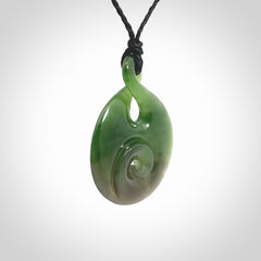 Hand carved New Zealand Jade Twist with Koru heart pendant. Unique Jade jewellery online for sale. Hand made Jade Twist with Koru, provided on adjustable cords and packaged in a woven kete pouch.