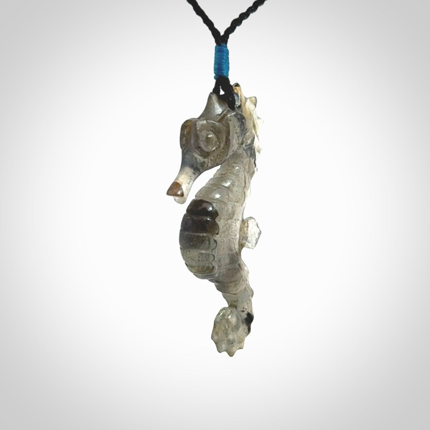 A hand carved labradorite seahorse pendant. We have carved this from beautiful labradorite and we bind them with our hand-plaited cords. The cords are a waxed polyester so they are durable and strong. We ship these worldwide with express courier anywhere in the world.