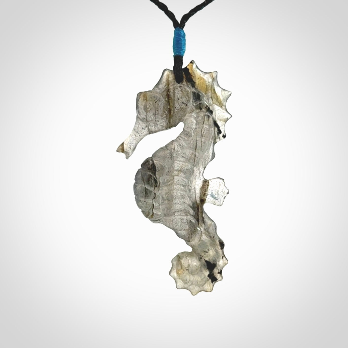 A hand carved labradorite seahorse pendant. We have carved this from beautiful labradorite and we bind them with our hand-plaited cords. The cords are a waxed polyester so they are durable and strong. We ship these worldwide with express courier anywhere in the world.