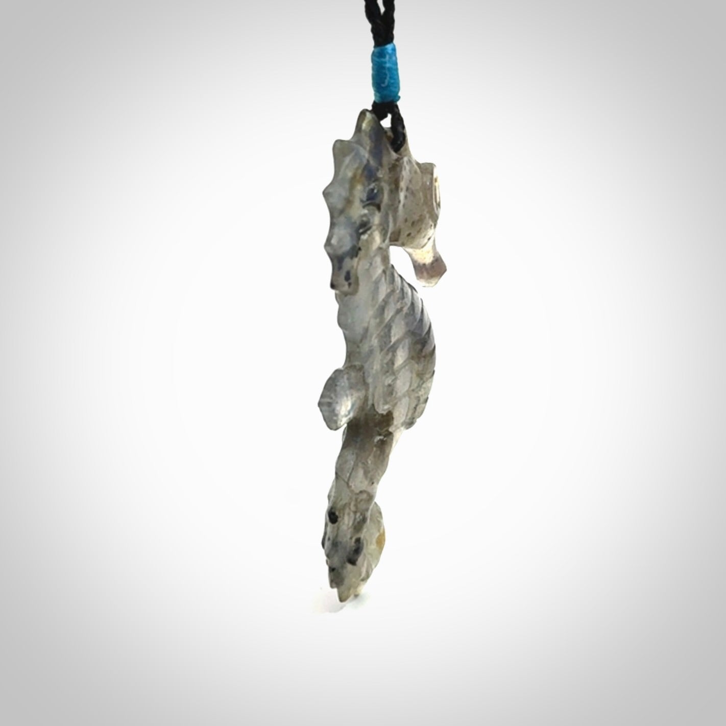A hand carved labradorite seahorse pendant. We have carved this from beautiful labradorite and we bind them with our hand-plaited cords. The cords are a waxed polyester so they are durable and strong. We ship these worldwide with express courier anywhere in the world.