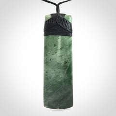 A large and beautiful hand carved toki pendant. This piece is carved from New Zealand jade by NZ Pacific. This is a wonderful large toki bound with a hand-plaited black cord and a traditional black lashing. A beautiful, traditional toki for sale online.