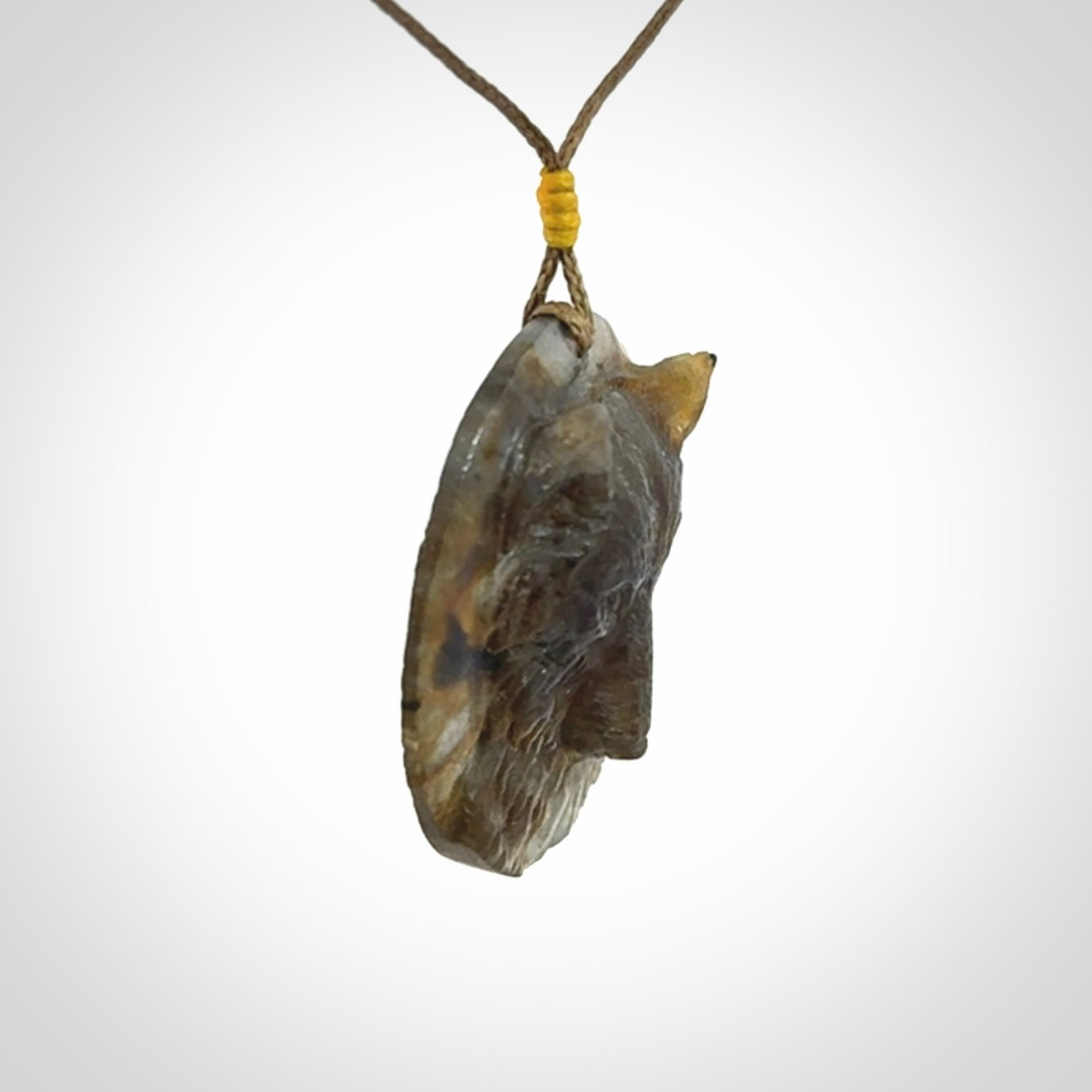 This is a hand carved wolf pendant made from Labradorite stone.