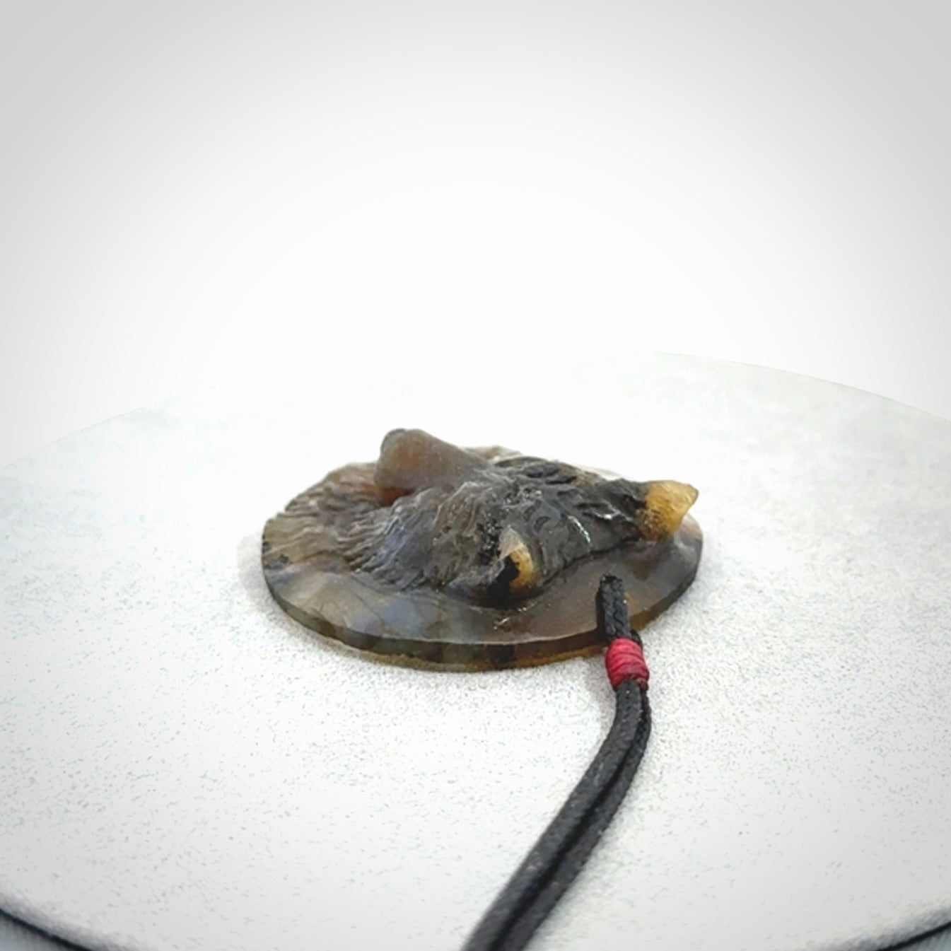 This is a hand carved wolf pendant made from Labradorite stone.
