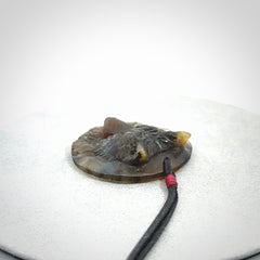 This is a hand carved wolf pendant made from Labradorite stone.