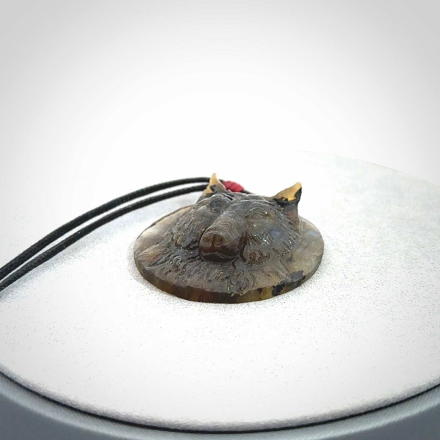 This is a hand carved wolf pendant made from Labradorite stone.