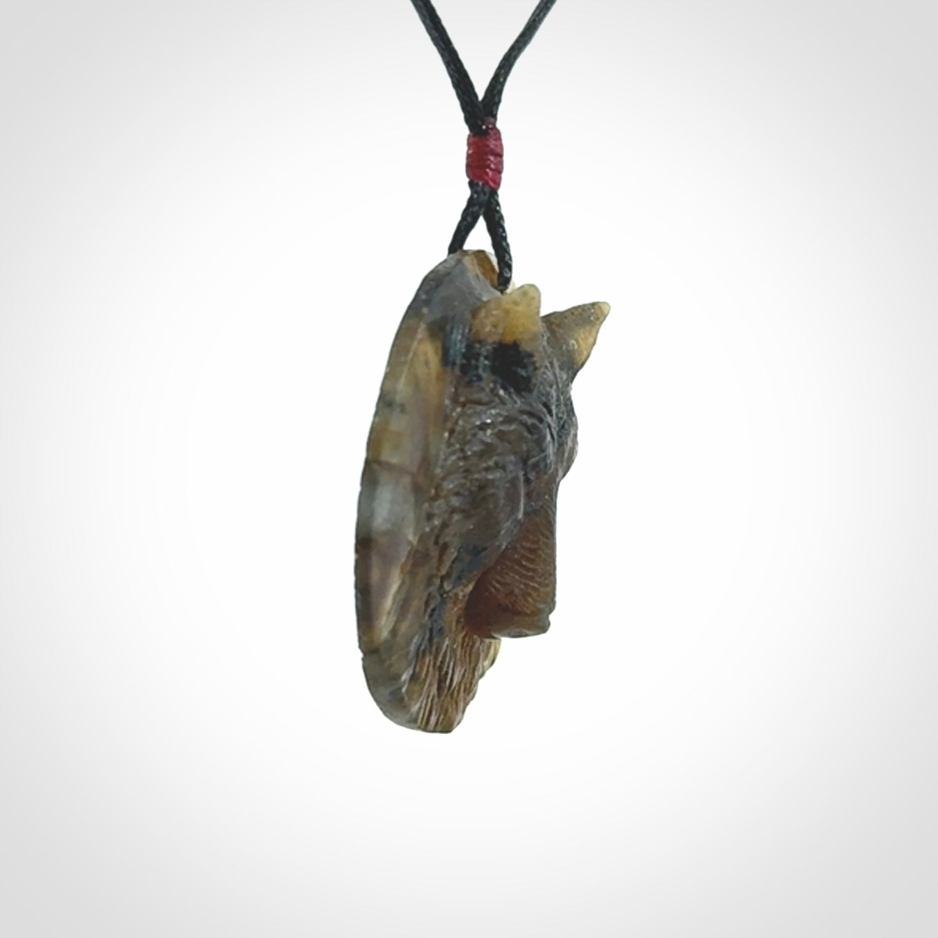 This is a hand carved wolf pendant made from Labradorite stone.