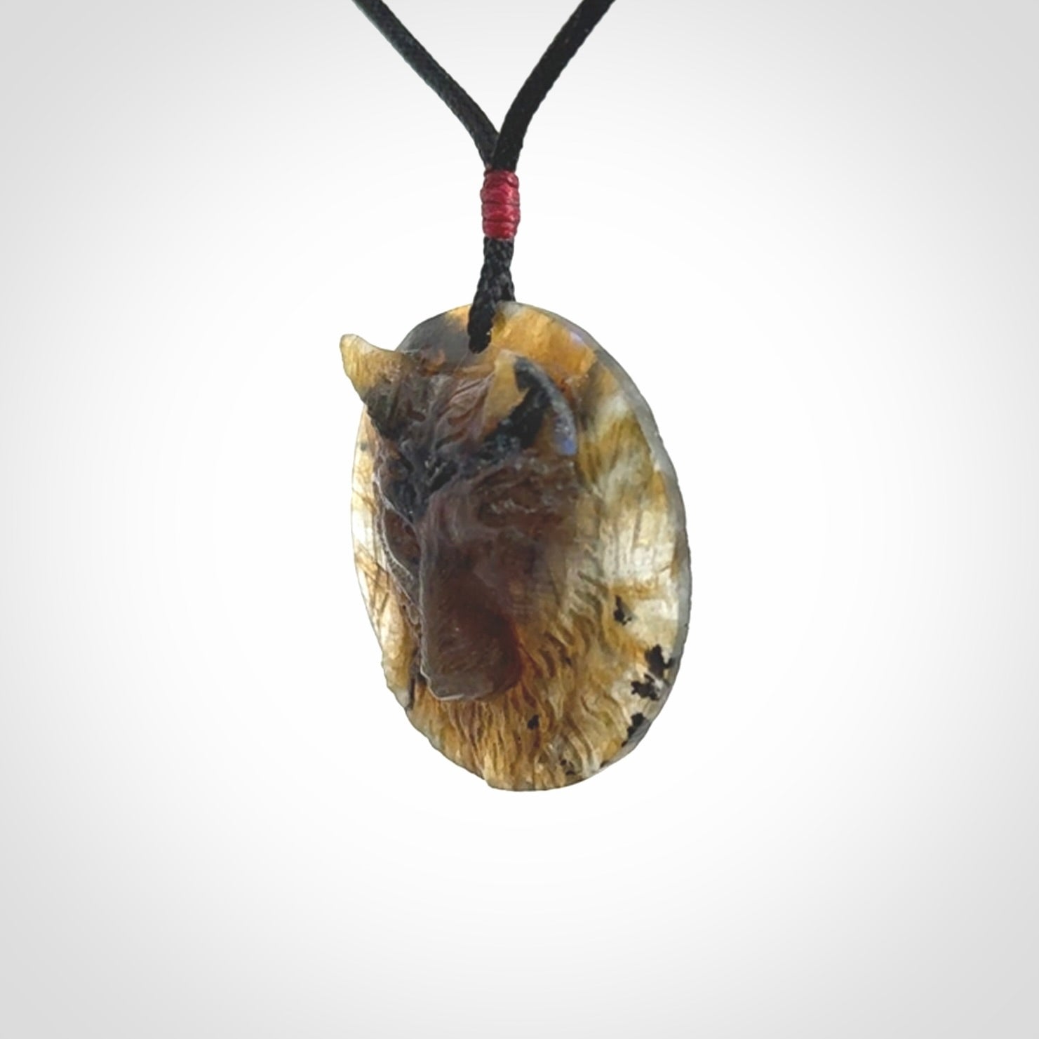 This is a hand carved wolf pendant made from Labradorite stone.