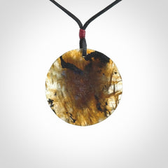This is a hand carved wolf pendant made from Labradorite stone.