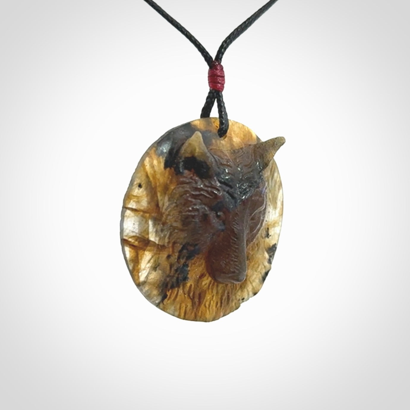 This is a hand carved wolf pendant made from Labradorite stone.