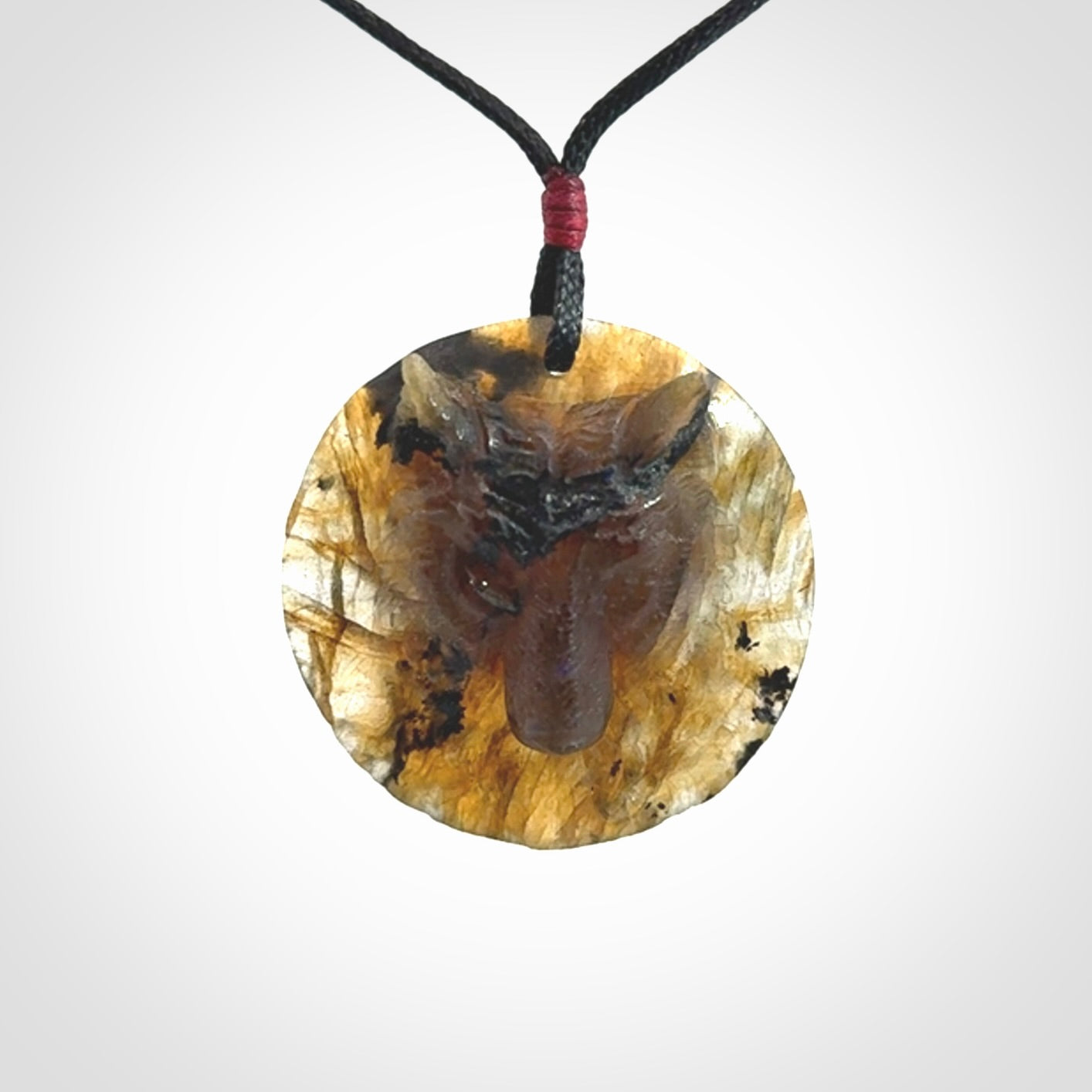 This is a hand carved wolf pendant made from Labradorite stone.