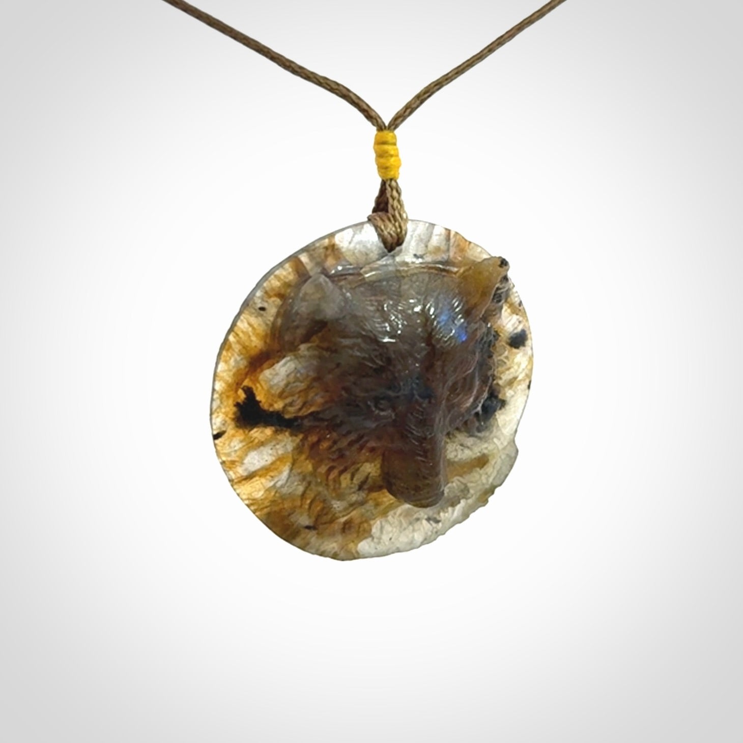 This is a hand carved wolf pendant made from Labradorite stone.