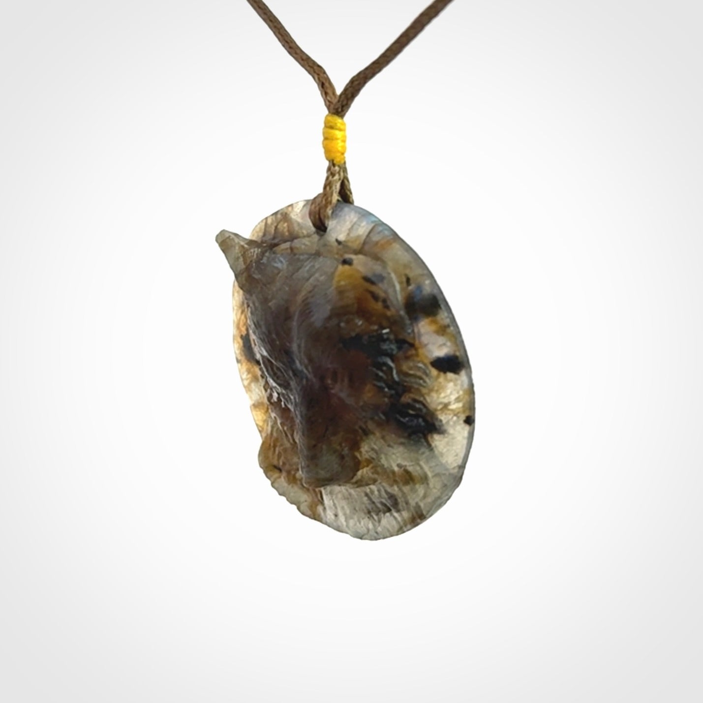 This is a hand carved wolf pendant made from Labradorite stone.