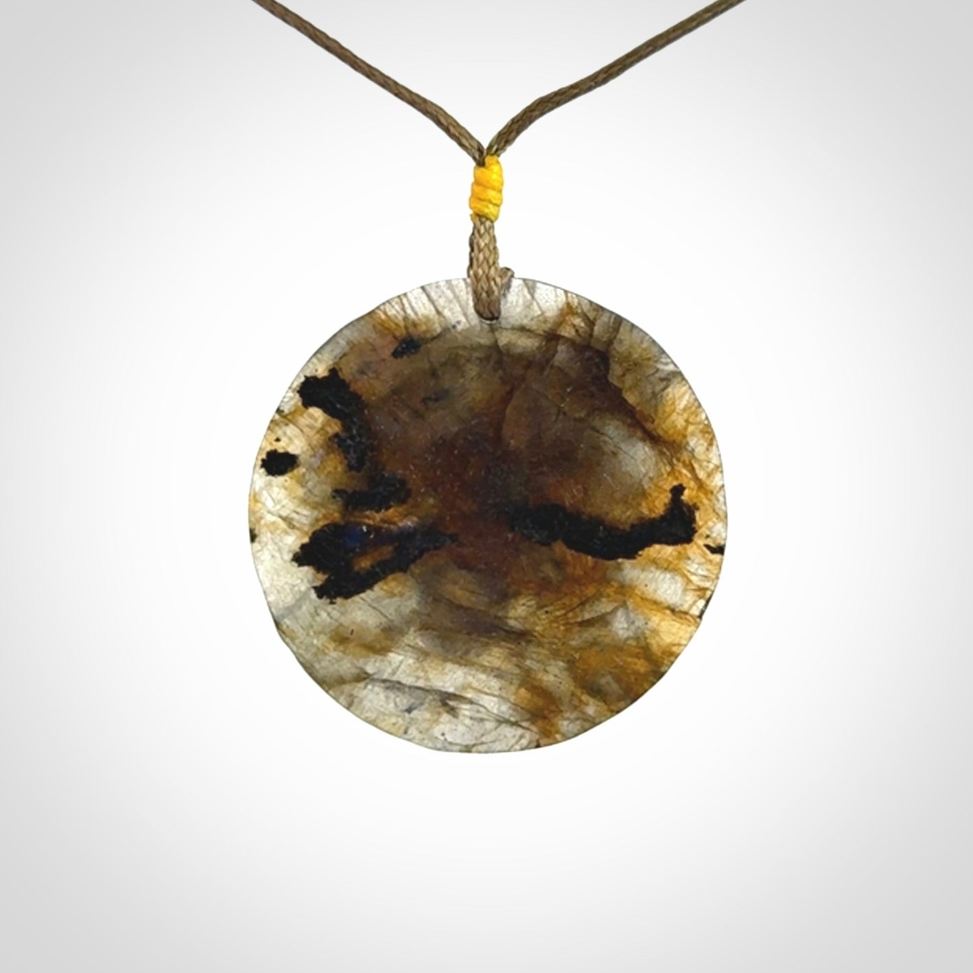 This is a hand carved wolf pendant made from Labradorite stone.