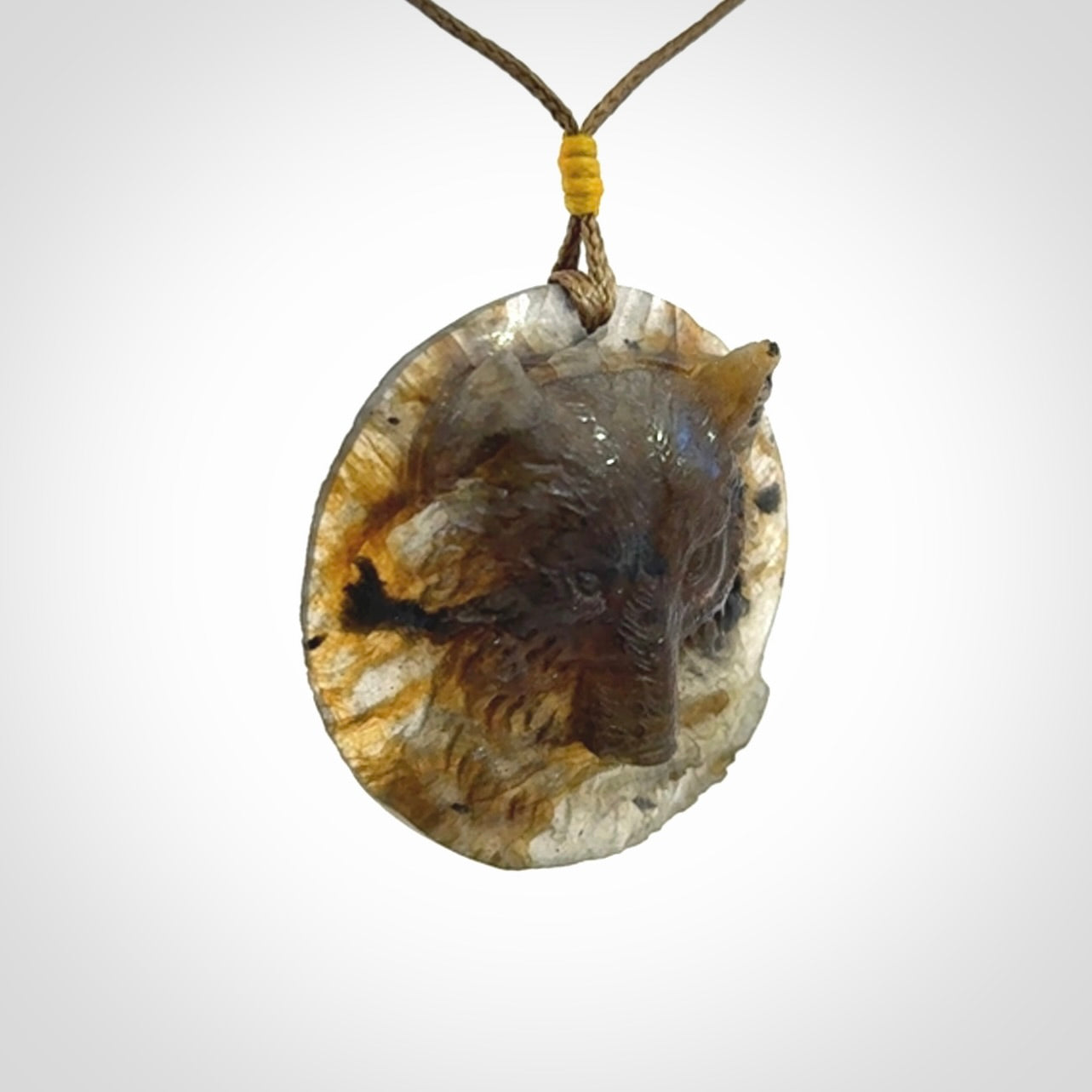 This is a hand carved wolf pendant made from Labradorite stone.