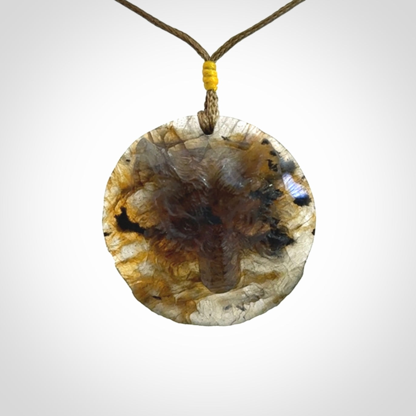 This is a hand carved wolf pendant made from Labradorite stone.