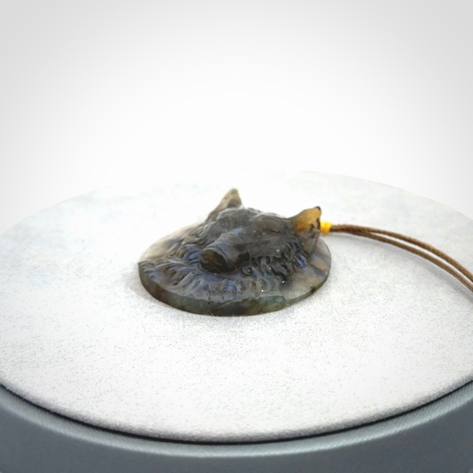This is a hand carved wolf pendant made from Labradorite stone.