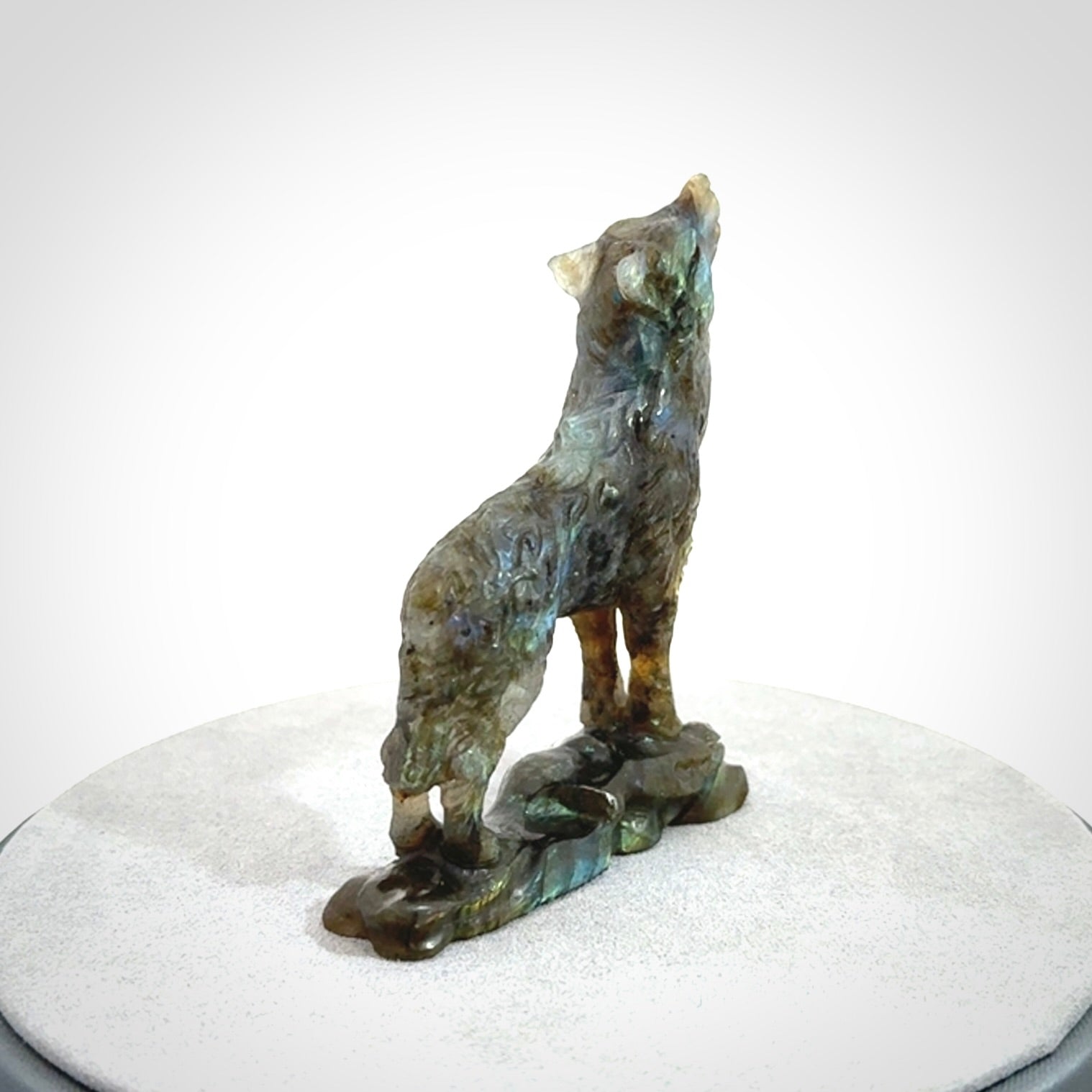 This is a hand carved wolf sculpture made from Labradorite stone.