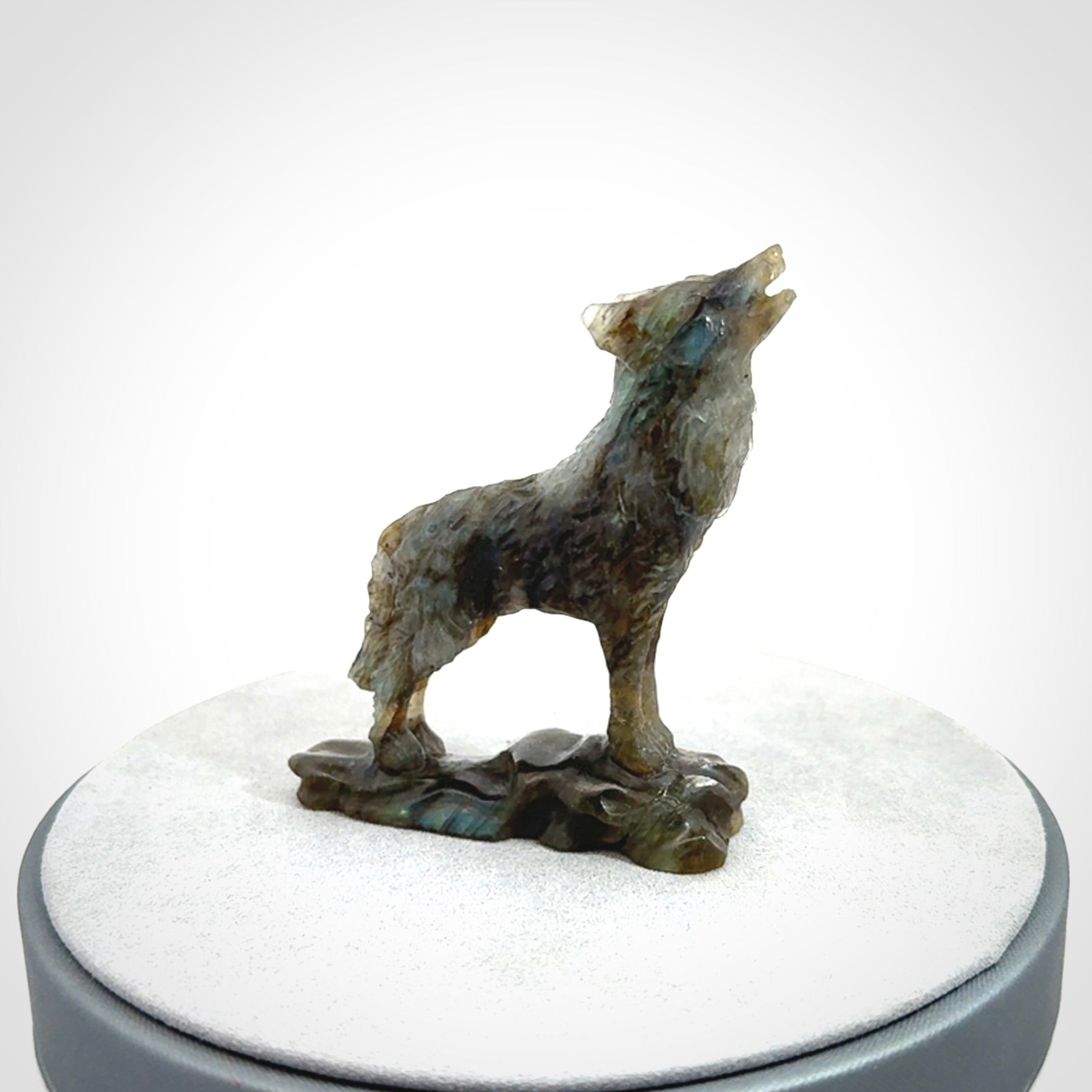 This is a hand carved wolf sculpture made from Labradorite stone.