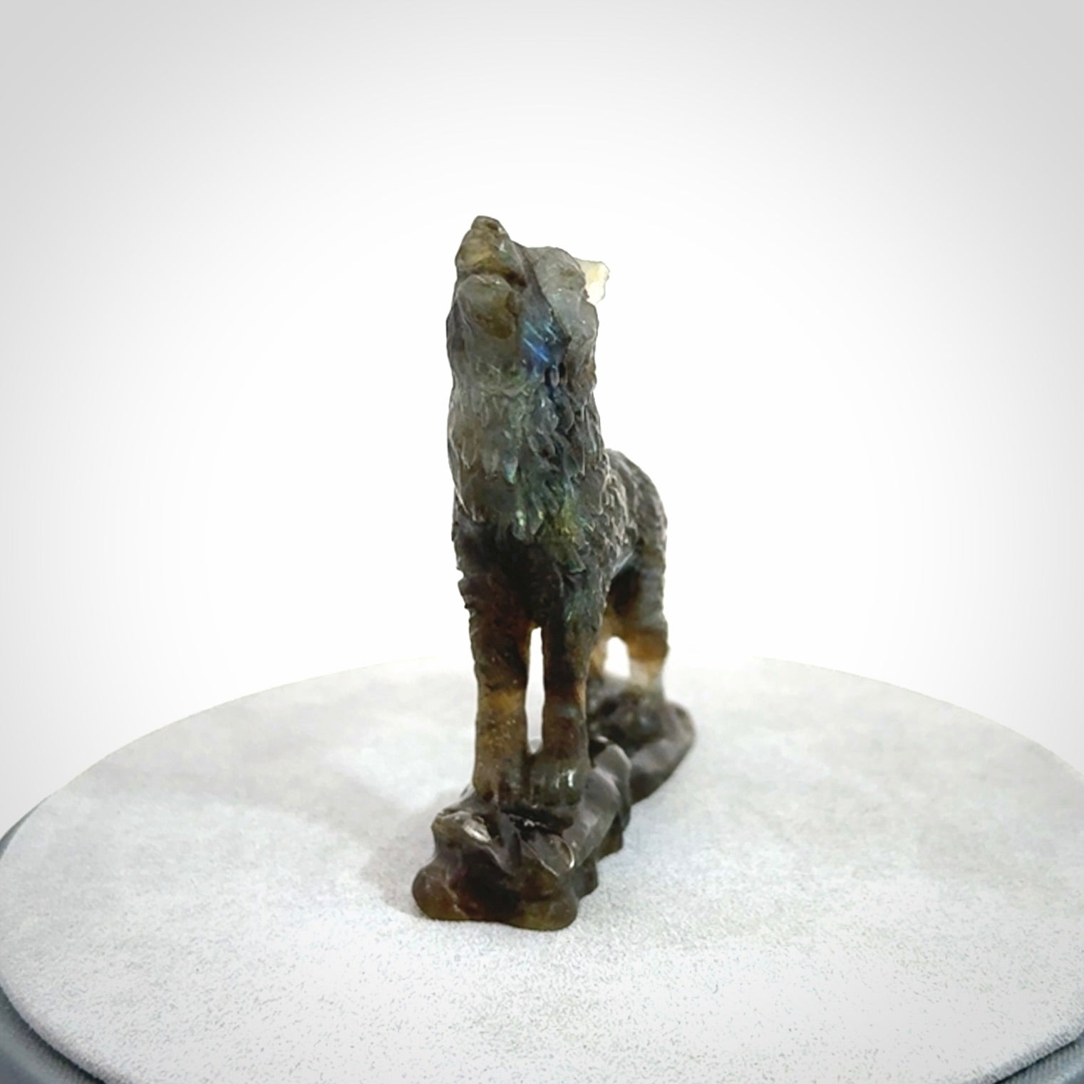This is a hand carved wolf sculpture made from Labradorite stone.